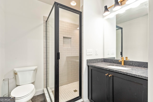 bathroom with vanity, toilet, and walk in shower