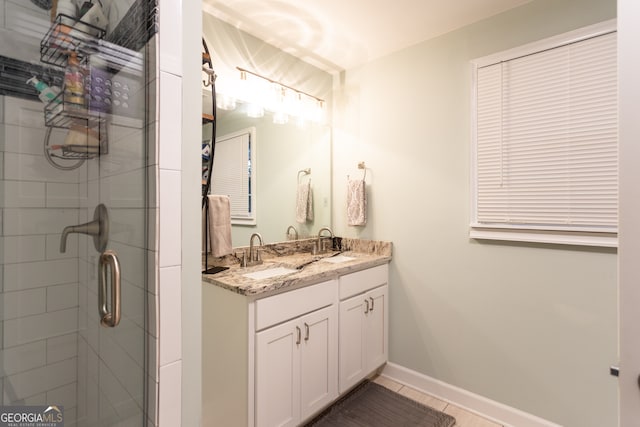 bathroom with tile patterned flooring, vanity, and a shower with shower door