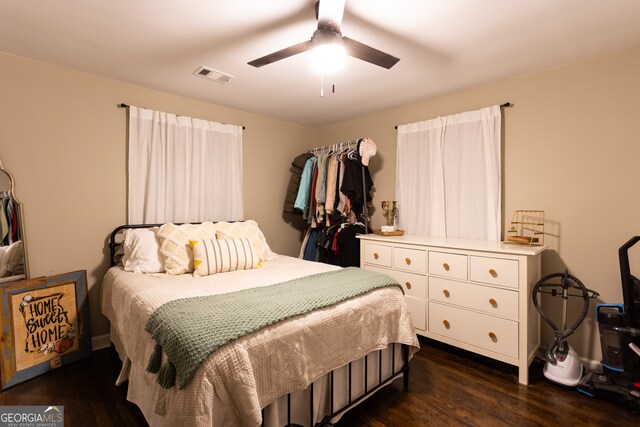 living room with ceiling fan and dark wood-type flooring