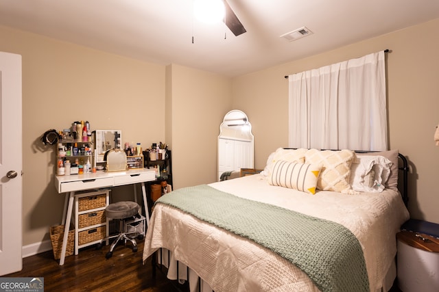 bedroom featuring dark hardwood / wood-style flooring and a crib