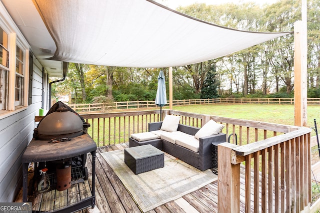 deck featuring grilling area and a lawn