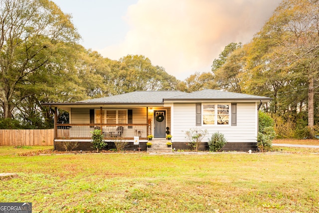 exterior space with an outbuilding, a front yard, a porch, and a garage