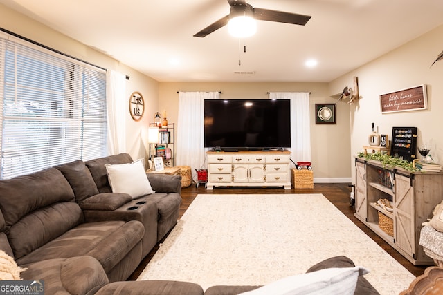 living room with dark hardwood / wood-style floors and ceiling fan