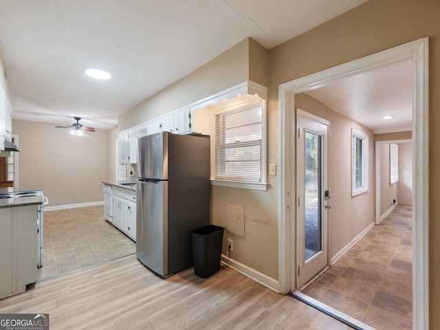 kitchen featuring ceiling fan, white cabinets, light hardwood / wood-style floors, and white appliances