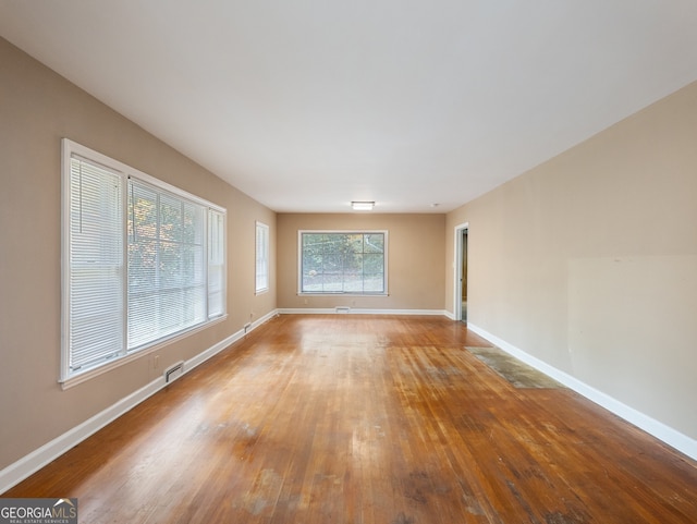 empty room with hardwood / wood-style flooring