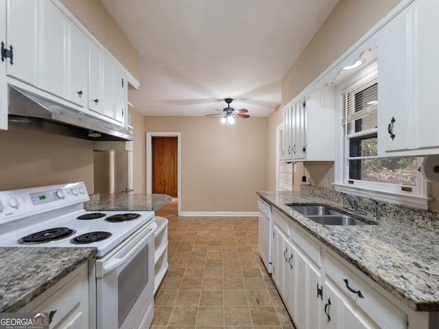 kitchen featuring white cabinets, white appliances, light stone countertops, and sink