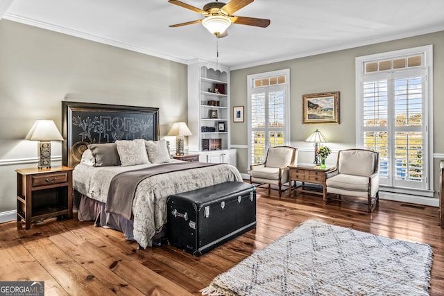 bedroom featuring multiple windows, ornamental molding, and ceiling fan