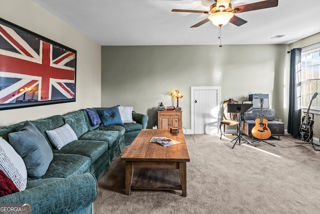 carpeted living room with ceiling fan