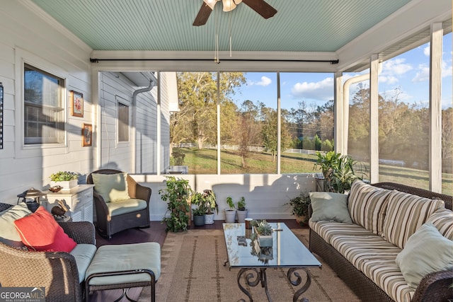 sunroom / solarium with a wealth of natural light and ceiling fan