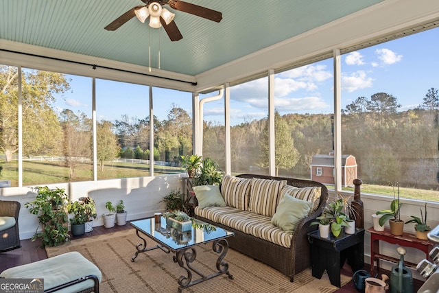 sunroom featuring ceiling fan