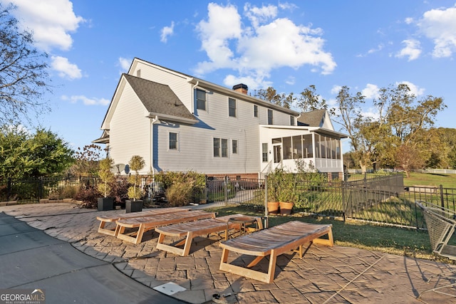 back of house featuring a patio area and a sunroom