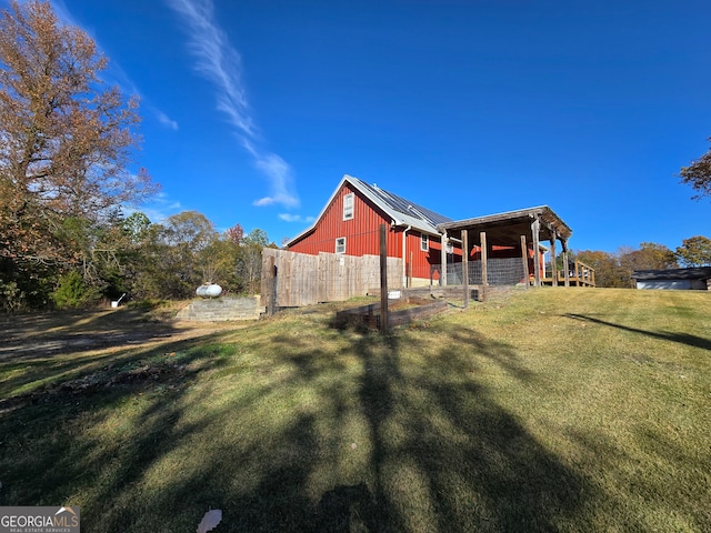 view of home's exterior featuring a lawn and an outdoor structure