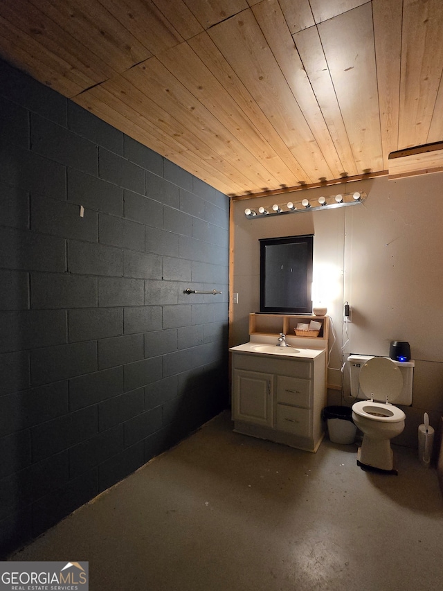 bathroom featuring vanity, toilet, wood ceiling, and concrete flooring