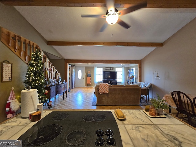 living room with vaulted ceiling with beams, ceiling fan, and a textured ceiling