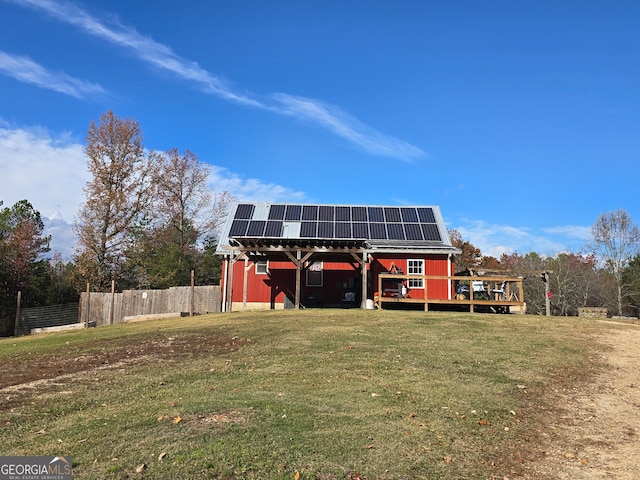 exterior space featuring solar panels and a yard