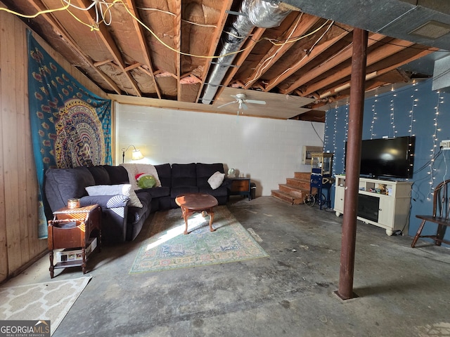 living room featuring ceiling fan and concrete flooring