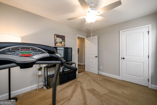 workout area with light carpet and ceiling fan