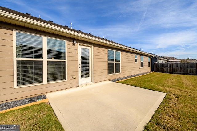 rear view of house featuring a patio area and a lawn