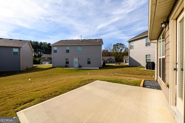 rear view of house featuring a patio area and a yard