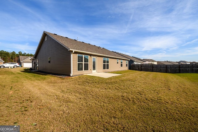 back of property featuring a lawn and a patio