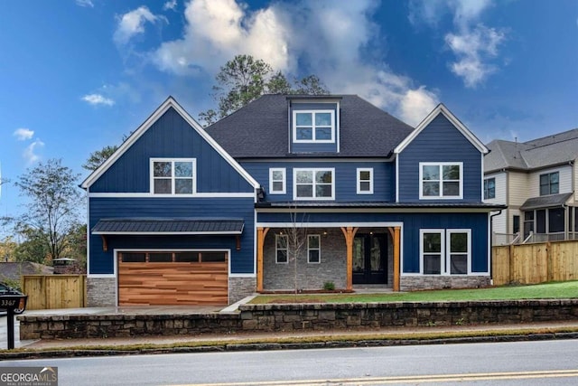 craftsman house with covered porch and a garage