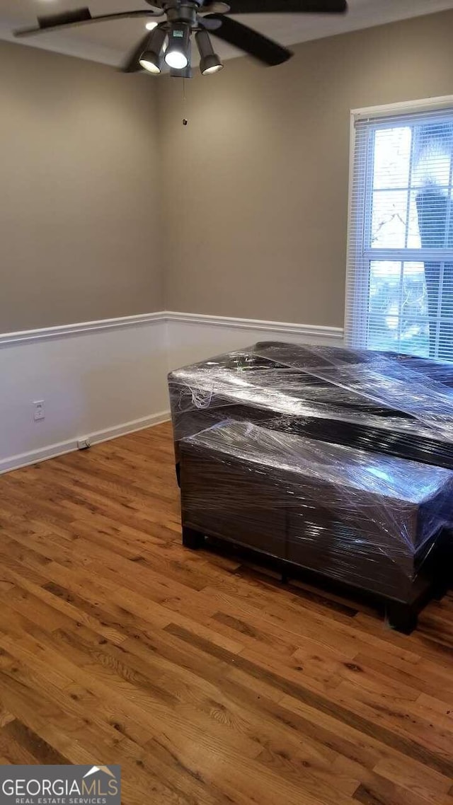 unfurnished bedroom featuring hardwood / wood-style flooring and ceiling fan