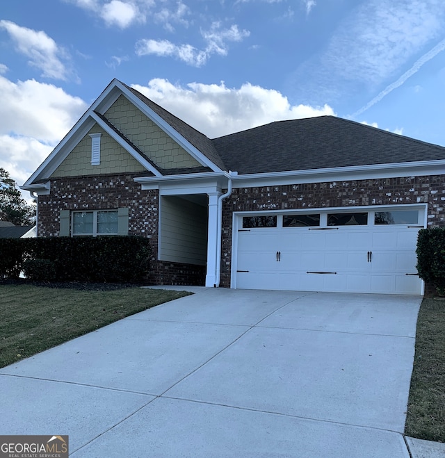 view of front of house featuring a front lawn and a garage