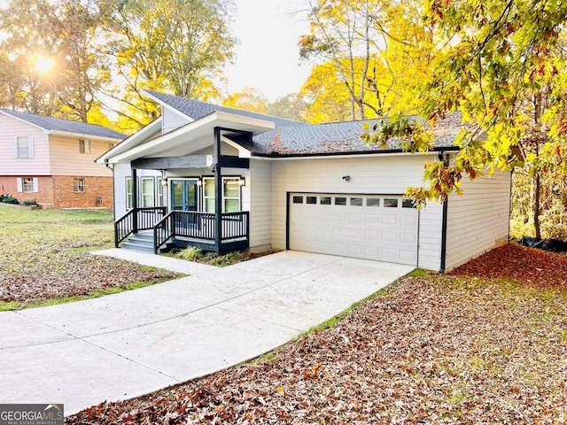 view of front of home featuring covered porch and a garage