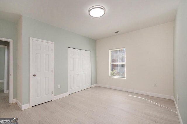 unfurnished bedroom with light wood-type flooring