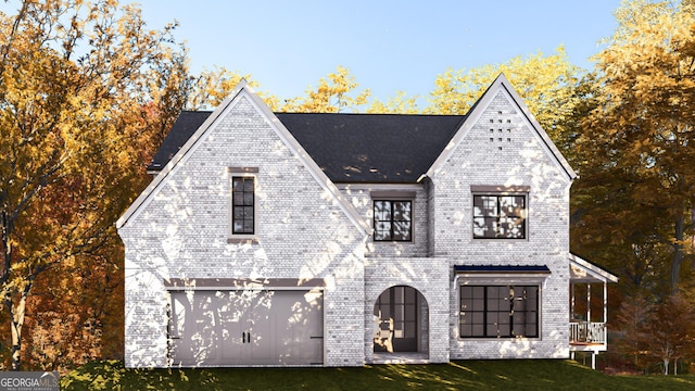 view of front of house with a front yard and a garage