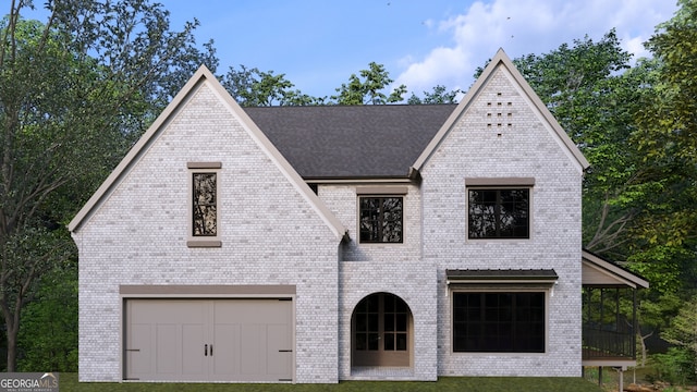 view of front of home featuring a front yard and a garage