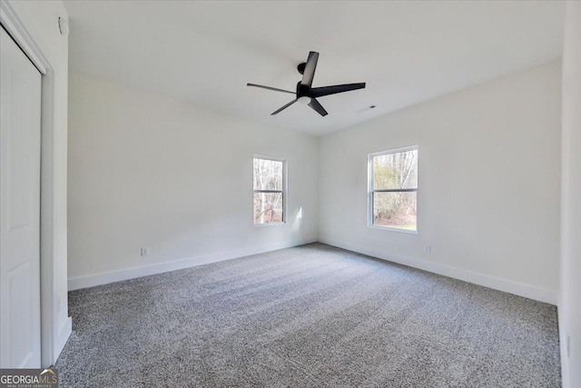 unfurnished room featuring carpet and ceiling fan