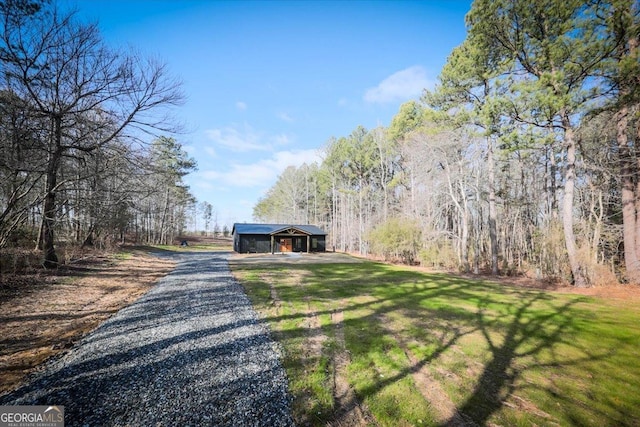 view of front of property featuring a front yard and a carport