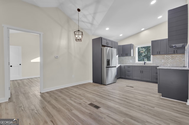 kitchen with gray cabinetry, light hardwood / wood-style flooring, and stainless steel refrigerator with ice dispenser