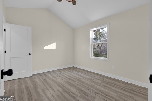 unfurnished room featuring light wood-type flooring, vaulted ceiling, and ceiling fan