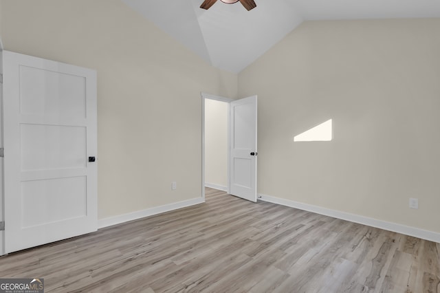 spare room with light wood-type flooring, high vaulted ceiling, and ceiling fan