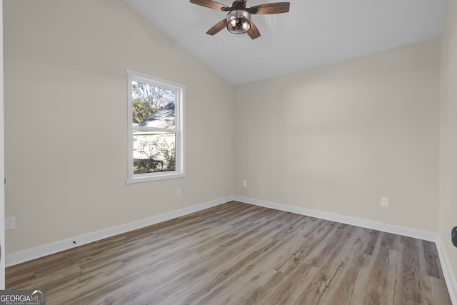 spare room with ceiling fan, light hardwood / wood-style floors, and vaulted ceiling