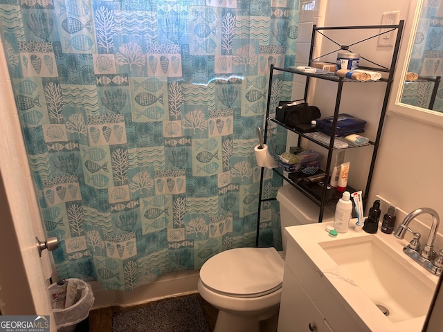 bathroom with vanity, toilet, and walk in shower