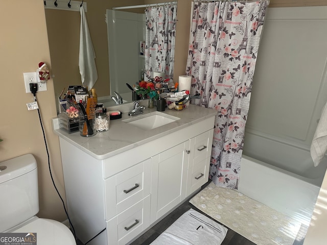 full bathroom featuring toilet, vanity, and shower / tub combo with curtain