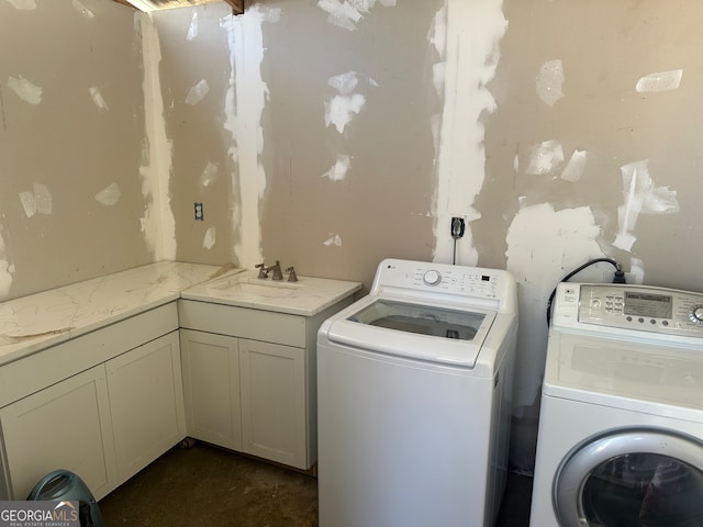 washroom featuring washer and clothes dryer, cabinets, and sink