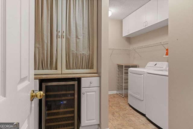 laundry room featuring cabinets, separate washer and dryer, a textured ceiling, and wine cooler