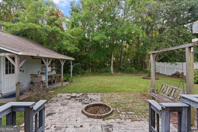 view of yard featuring a patio area and an outdoor fire pit