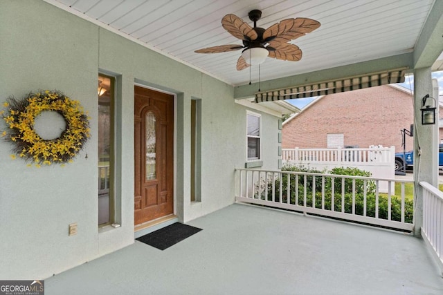 doorway to property with ceiling fan and covered porch