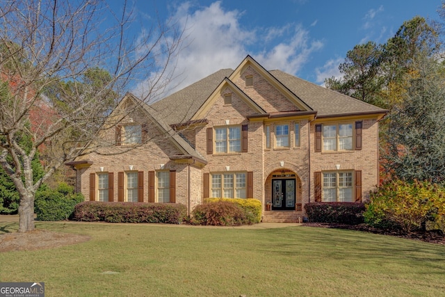 view of front of home with french doors and a front yard