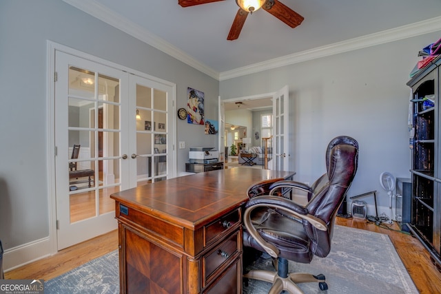 office space featuring ceiling fan, french doors, ornamental molding, and light wood-type flooring