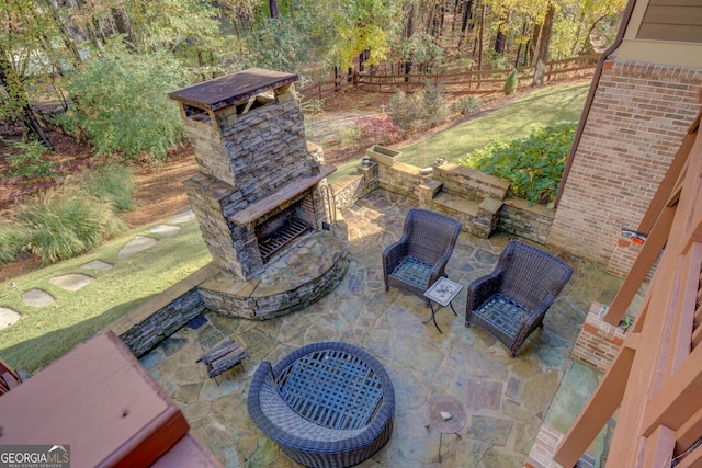 view of patio featuring an outdoor stone fireplace