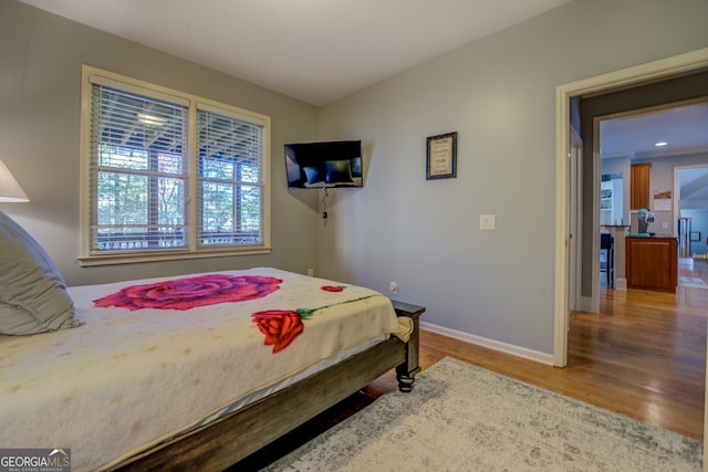 bedroom with hardwood / wood-style floors