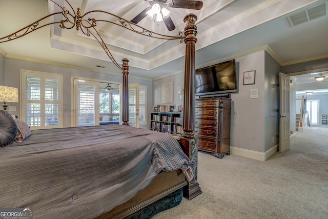 bedroom featuring a raised ceiling, crown molding, ceiling fan, and light carpet