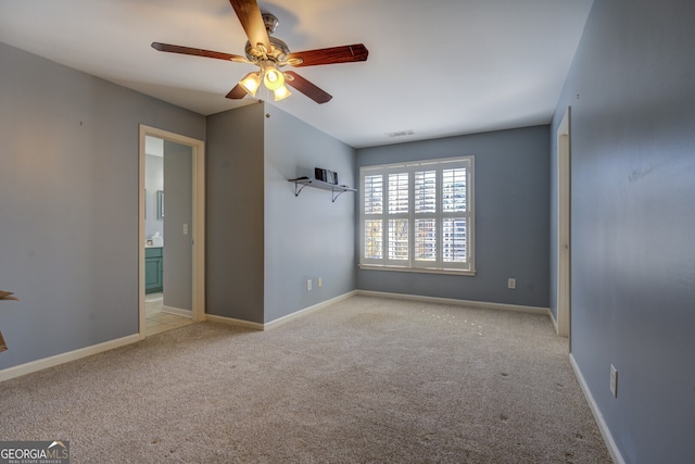 carpeted empty room featuring ceiling fan