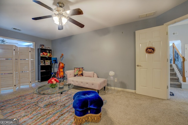 living area featuring ceiling fan and carpet